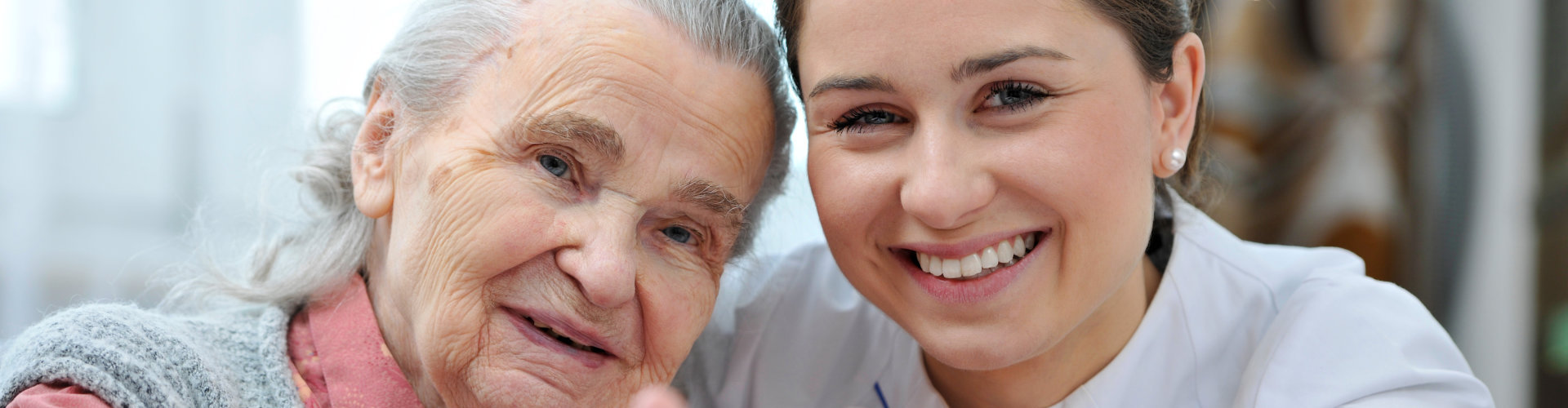 nurse smiling with elderly woman