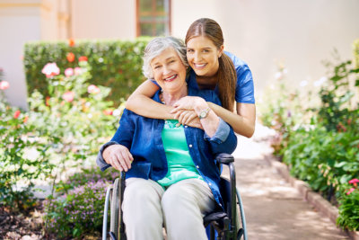 Caregiver and elder woman taking fresh air outside