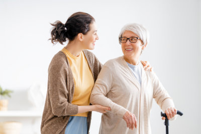 caregiver and elder woman smiling