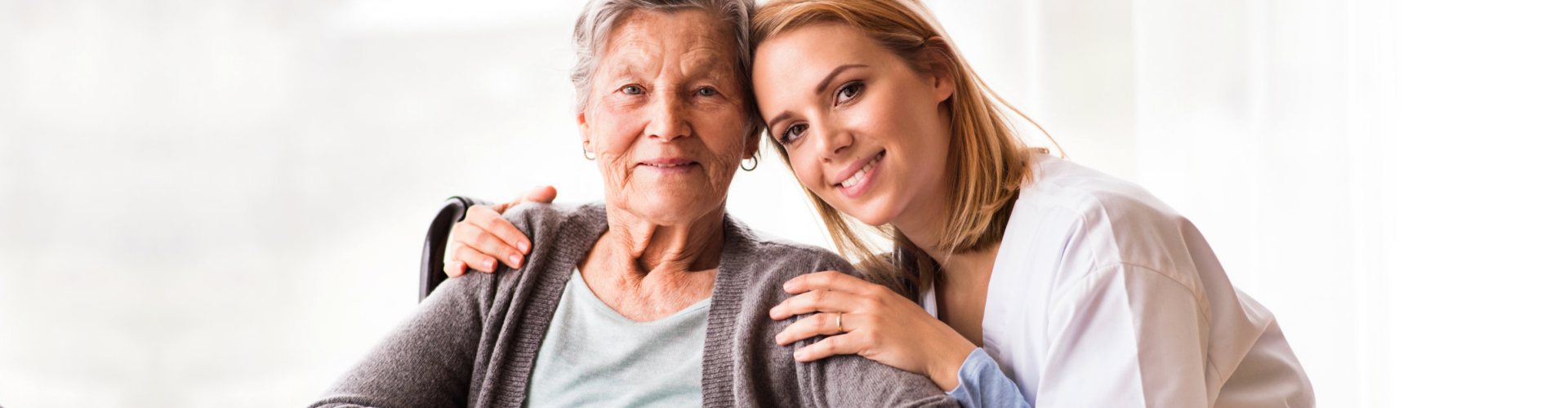 elderly woman smiling with caregiver