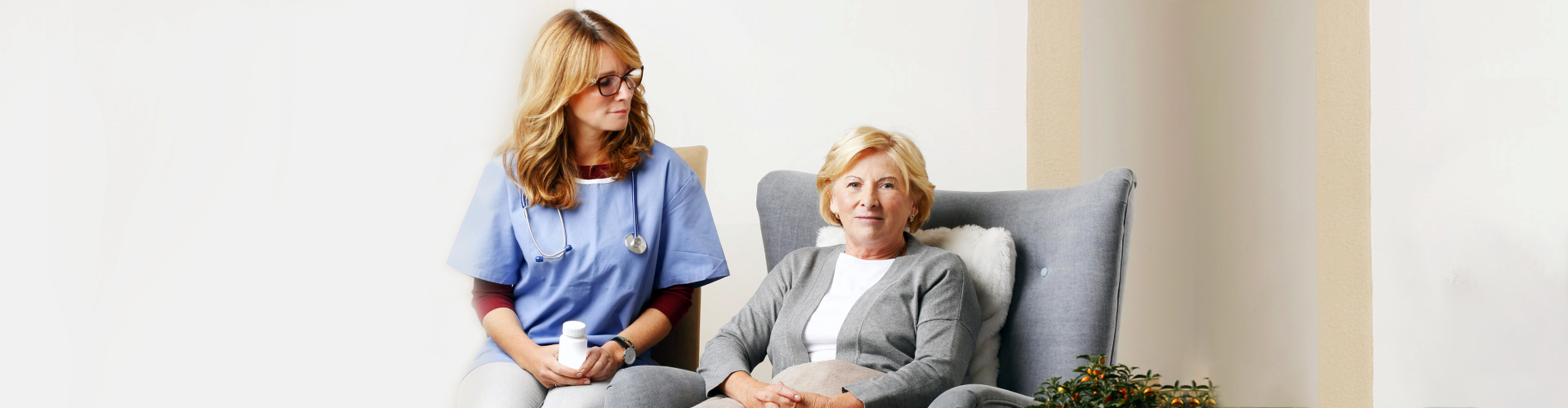 nurse attending to elderly woman