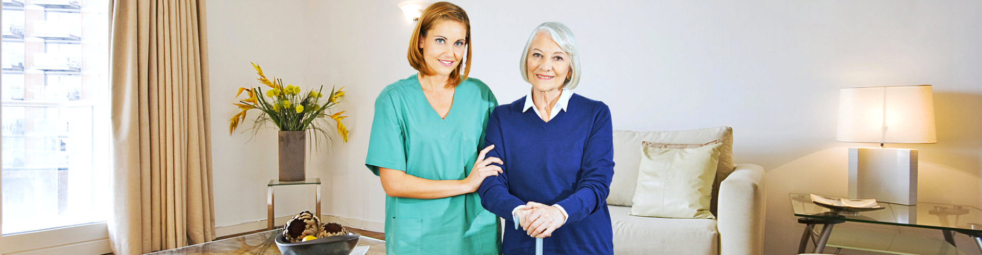 caregiver and elderly woman smiling