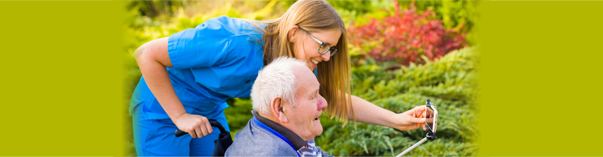 caregiver and elder man talking to a phone