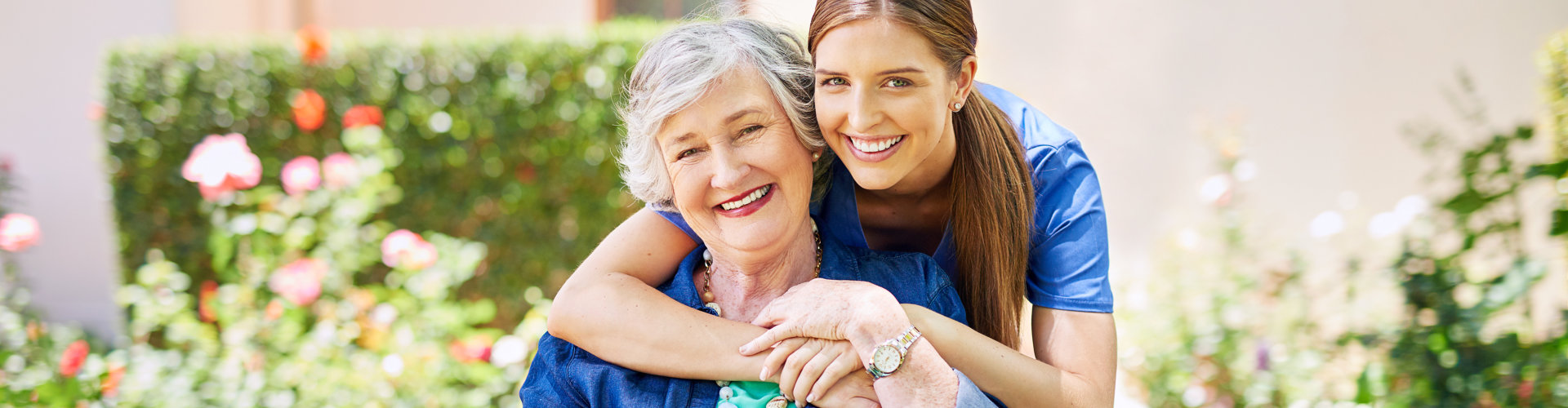 elder woman and caregiver smiling