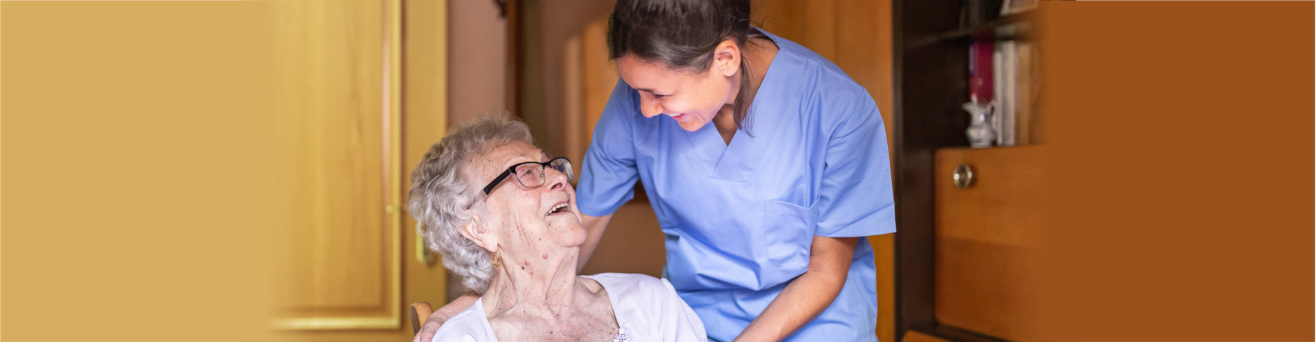 caregiver and elder woman smiling